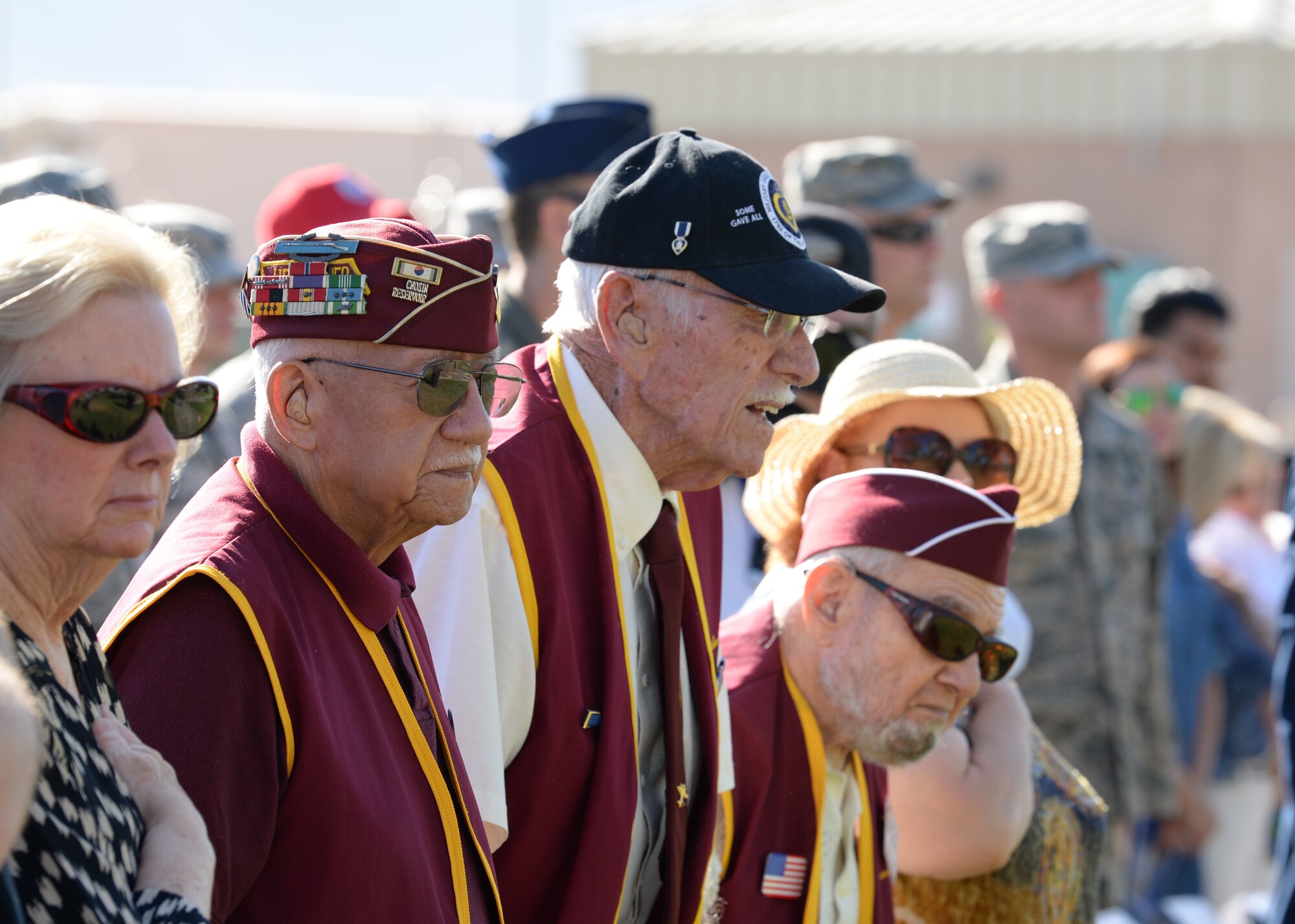 Prisoners of war and their family members stand during the POW/Missing in Action ceremony in Freedom Park on Nellis Air Force Base, Nev., Sept. 21, 2018.  Five former POWs and six formally MIA service members that were recently returned home, were honored at the ceremony. (U.S. Air Force photo by Airman 1st Class Bryan T. Guthrie)