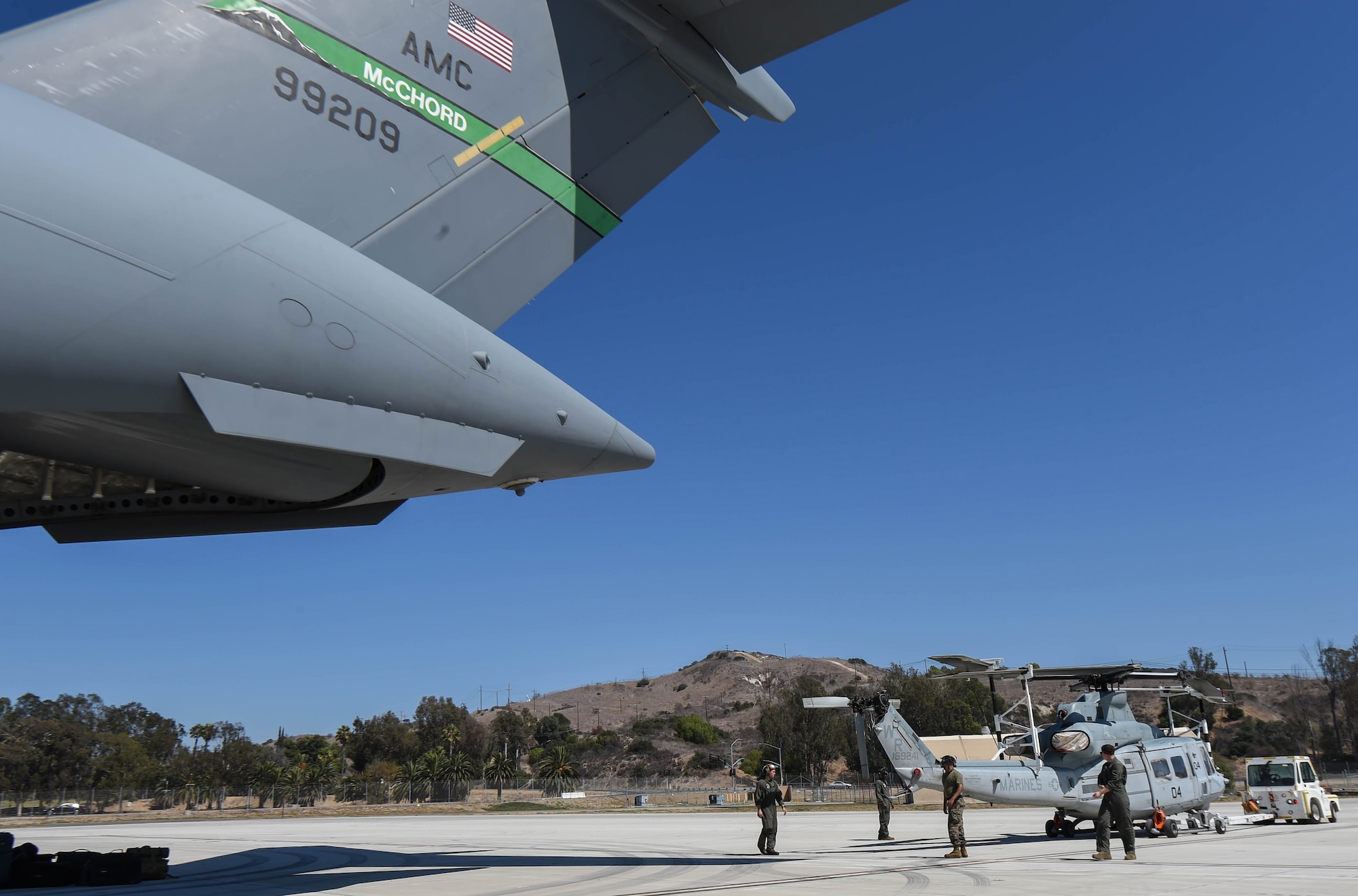 U.S. Marine Corps Marines prepare to load a UH-1Y Venom onto a C-17 Globemaster III at Camp Pendleton, Calif., Sept. 8, 2018. Airmen from the 4th Airlift Squadron transported the helicopter to the Czech Republic so both aircraft could participate in the NATO Days Air Show held there. (U.S. Air Force photo by Senior Airman Tryphena Mayhugh)