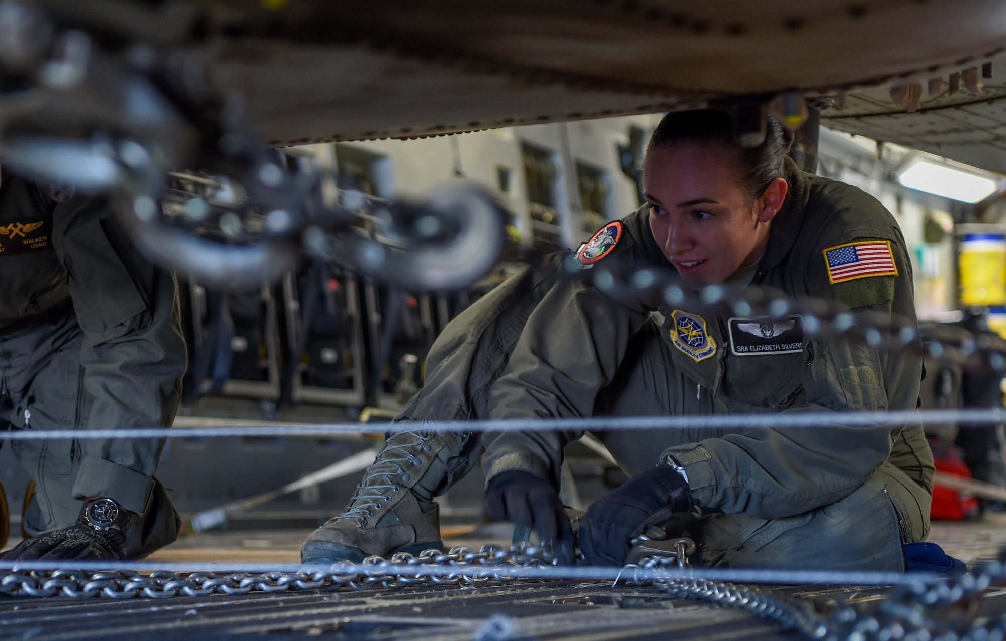 U.S. Air Force Senior Airman Elizabeth Silvers, 4th Airlift Squadron loadmaster, chains a U.S. Marine Corps UH-1Y Venom to a C-17 Globemaster III at Václav Havel Airport Prague, Czech Republic, Sept. 10, 2018. The helicopter had to be held down with safety chains in case it slipped during the offload. (U.S. Air Force photo by Senior Airman Tryphena Mayhugh)