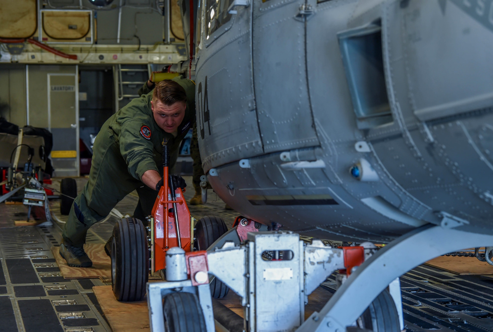 U.S. Air Force Staff Sgt. Cameron Morris, 4th Airlift Squadron loadmaster, helps push a U.S. Marine Corps UH-1Y Venom off a C-17 Globemaster III at Václav Havel Airport Prague, Czech Republic, Sept. 10, 2018. Morris, other 4th AS Airmen and ten marines worked together to load and offload the helicopter at various destinations. (U.S. Air Force photo by Senior Airman Tryphena Mayhugh)