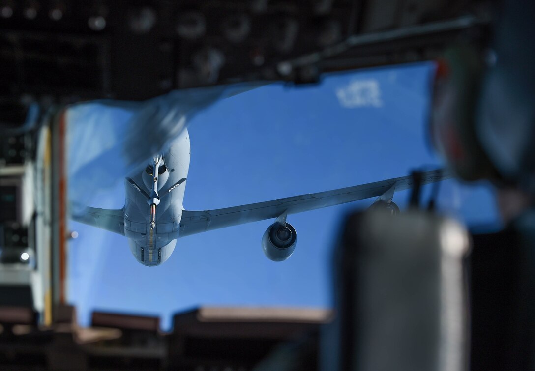 A Nebraska Air National Guard KC-135 Stratotanker gets into position in front of a McChord Field. Wash., C-17 Globemaster III during Exercise Ample Strike near Prague, Czech Republic, Sept. 12, 2018. Pilots from the 4th Airlift Squadron received training and qualifications in air refueling during the exercise. (U.S. Air Force photo by Senior Airman Tryphena Mayhugh)