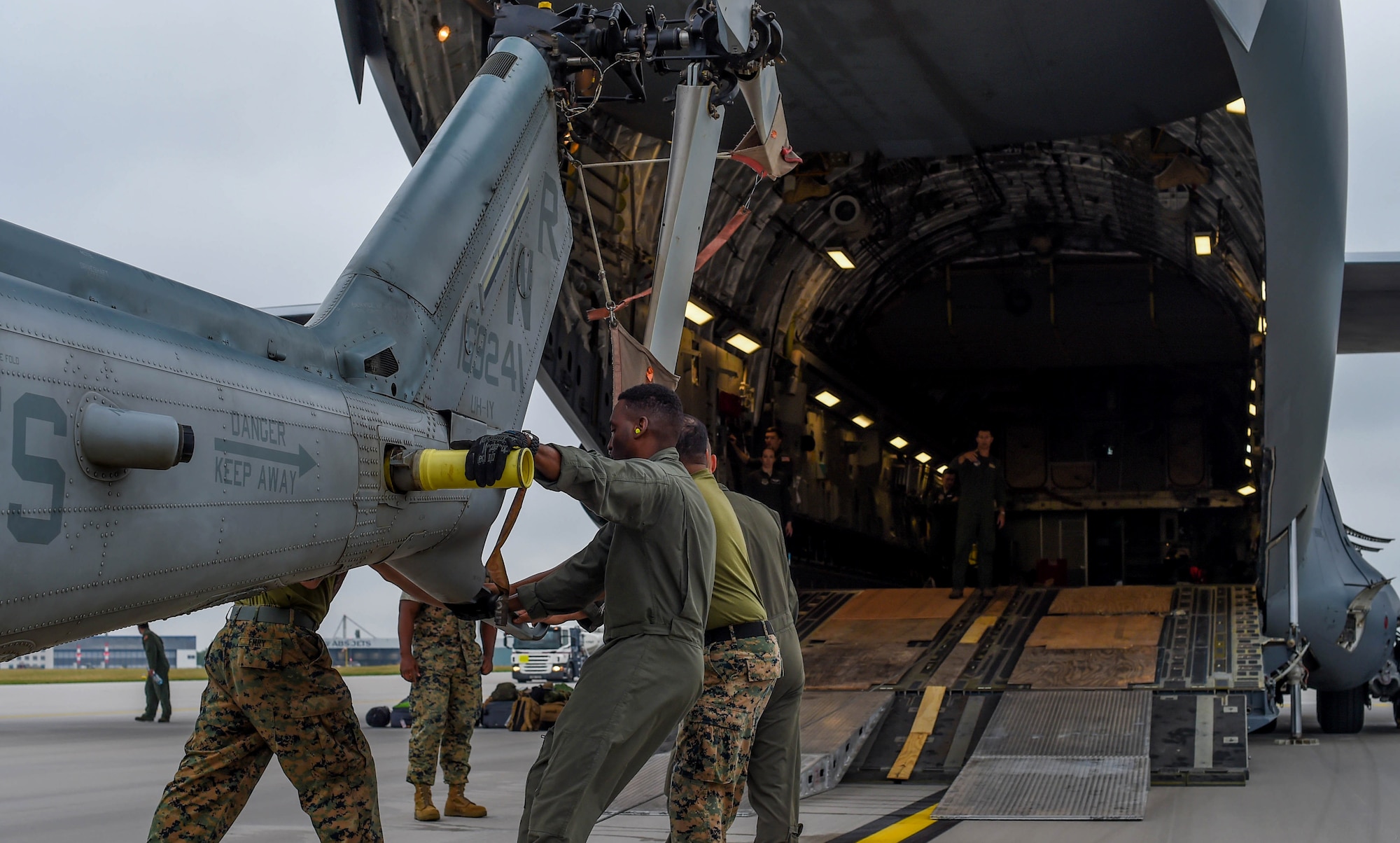 U.S. Marine Corps Marines load a UH-1Y Venom onto a U.S. Air Force C-17 Globemaster III at Václav Havel Airport Prague, Czech Republic, Sept. 14, 2018. Nelson and other 4th AS Airmen transported the helicopter and ten Marines to the Czech Republic to participate in the NATO Days Air Show. (U.S. Air Force photo by Senior Airman Tryphena Mayhugh)
