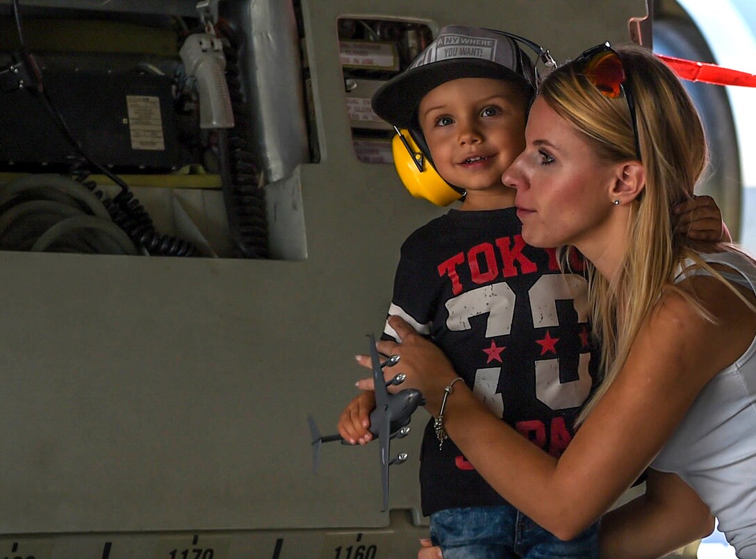 A child holds a model of a C-17 Globemaster III while touring inside a McChord Field, Wash., C-17 during the NATO Days Air Show in Ostrava, Czech Republic, Sept. 16, 2018. Patrons of the air show were able to walk inside the aircraft and ask 4th Airlift Squadron Airmen questions about the plane. (U.S. Air Force photo by Senior Airman Tryphena Mayhugh)