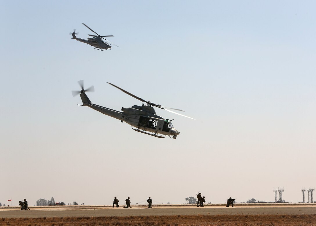 Marines with Marine Light Attack Helicopter Squadron (HMLA) 169 pass overhead during the Marine Air Ground Task Force demonstration at the Marine Corps Air Station Miramar air show, MCAS Miramar, Calif., Sept. 28. This years air show honors "100 years of women in the Marine Corps" by featuring several performances and displays that highlight accomplishments and milestones women made since the first female enlistee, Olpha May Johnson, who joined the service in 1918. (U.S. Marine Corps photo by Cpl. Joshua S. McAlpine)