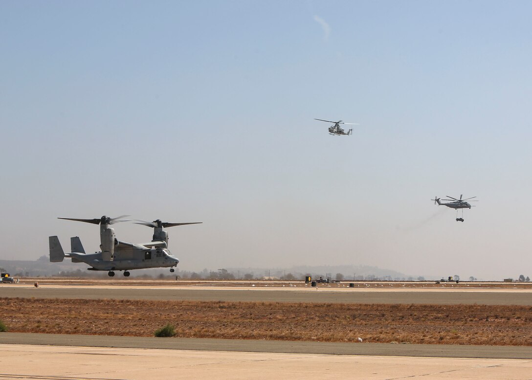 Marines demonstrate the aerial capabilities of a Marine Air-Ground Task Force during the MAGTF demonstration at the 2018 Marine Corps Air Station Miramar Air Show on MCAS Miramar, Calif., Sept. 28. This years air show honors "100 years of women in the Marine Corps" by featuring several performances and displays that highlight accomplishments and milestones women made since the first female enlistee, Opha May Johnson, who joined the service in 1918. (U.S. Marine Corps photo by Cpl. Joshua S. McAlpine/ Released)