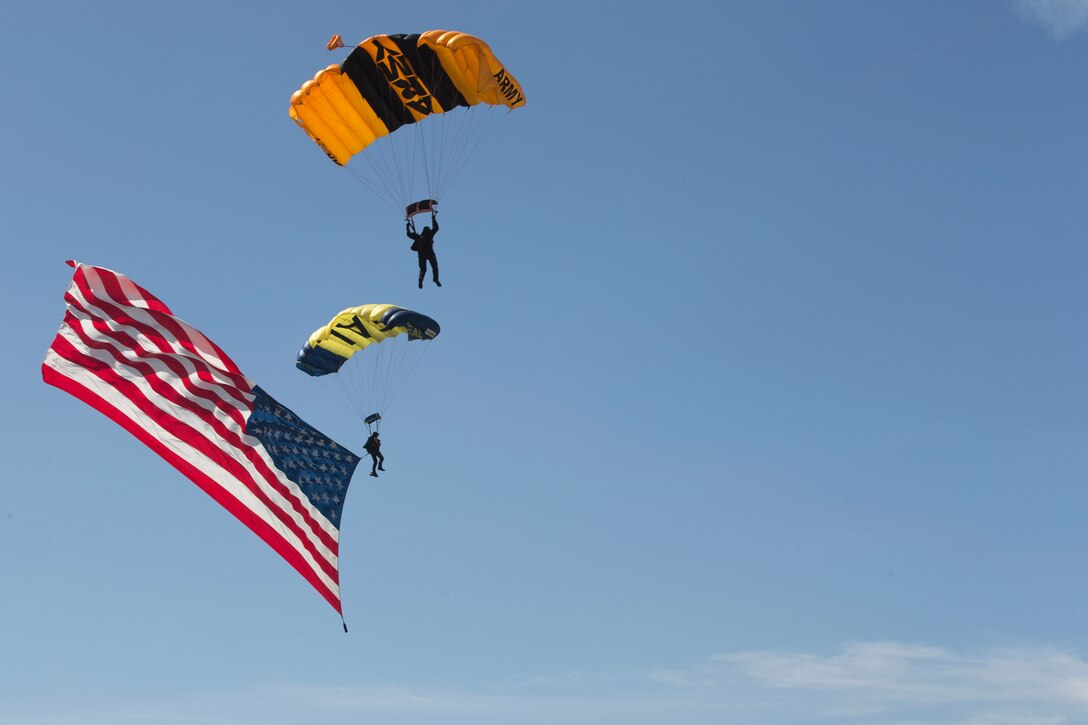 A member of the U.S. Navy "Leap Frogs" and a member of the U.S. Army Golden Knights parachute toward their target during the 2018 Marine Corps Air Station Miramar Air Show opening ceremony at MCAS Miramar, Calif., Sept. 28. This years air show honors “100 years if women in the Marine Corps” by featuring several performances and displays that highlight accomplishments and milestones since the first female enlistee, Opha May Johnson, who joined the service in 1918. (U.S. Marine Corps photo by Lance Cpl. Maritza Vela)