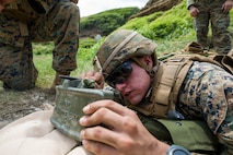 A U.S. Marine aims a M18A1 Claymore mine at targets during demolition and explosives training, part of the Advanced Infantry Marine Course (AIMC) hosted by the School of Infantry-West (SOI-W), at the Kaneohe Bay Range Training Facility, Marine Corps Base Hawaii (MCBH), Sept. 25, 2018. Students that had little to no experience using explosive devices were instructed on how to safely prepare, prime and use them. The AIMC is an advanced infantry course for future squad leaders encompassing classroom lectures, ranges and field exercises. (U.S. Marine Corps photo by Sgt. Jesus Sepulveda Torres)