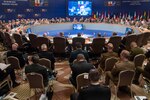 NATO chiefs of defense meet around a large, round table.