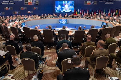 NATO chiefs of defense meet around a large, round table.