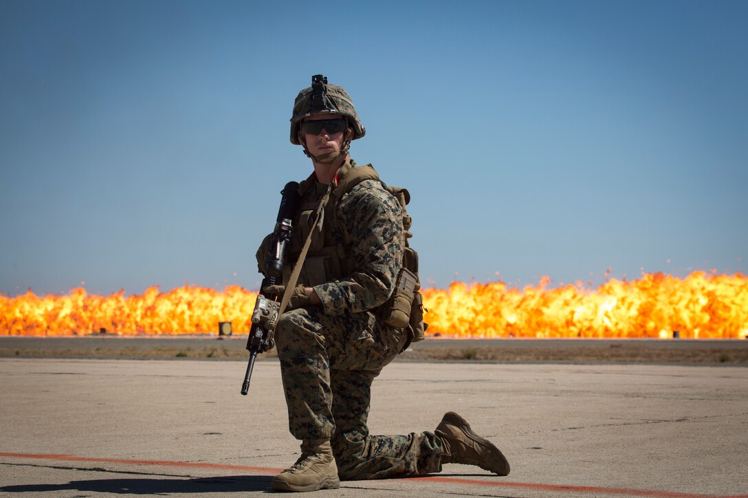 A Marine with 1st Marine Division takes a high knee during the Marine Air-Ground Task Force demonstration at the 2018 Marine Corps Air Station Miramar Air Show on MCAS Miramar, Calif., Sept. 29. This year's air show honors "100 years of women in the Marine Corps" by featuring several performances and displays that highlight the accomplishments and milestones women have made since the first female enlistee, Olpha May Johnson, who joined the service in 1918. (U.S. Marine Corps photo by Cpl. Becky Cleveland)