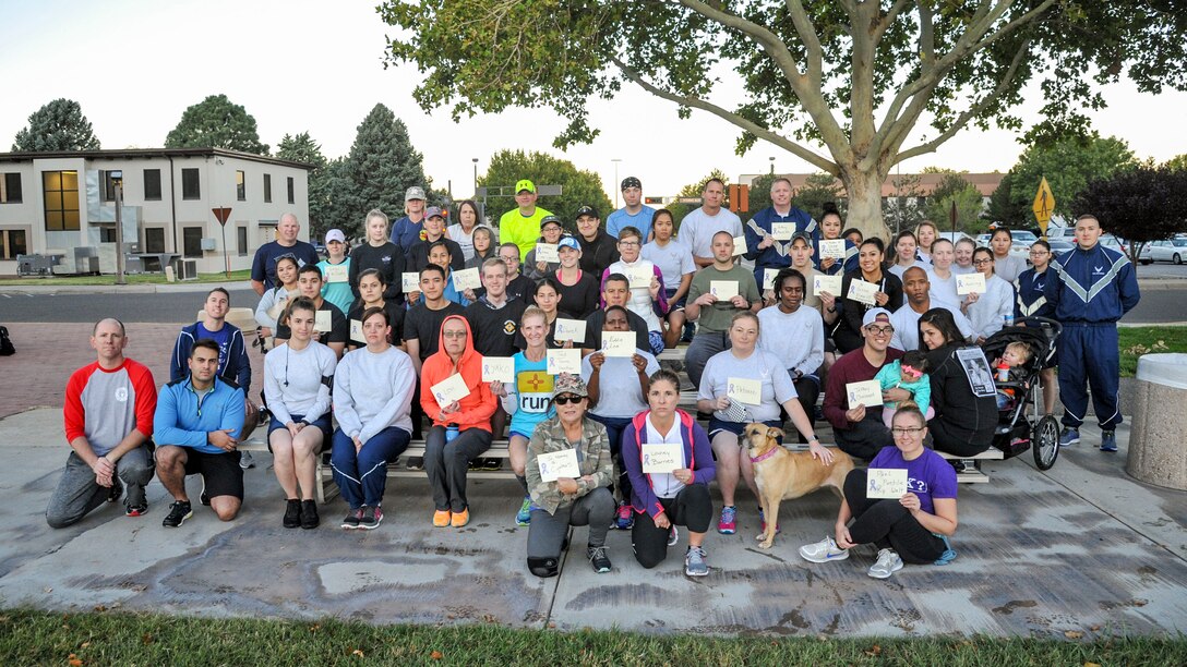 Participants in the Suicide Prevention "We won't back down" run/walk display the people they have lost to suicide prior to hitting the track Sept. 28 at Hardin Field. (U.S. Air Force photo by Jim Fisher)