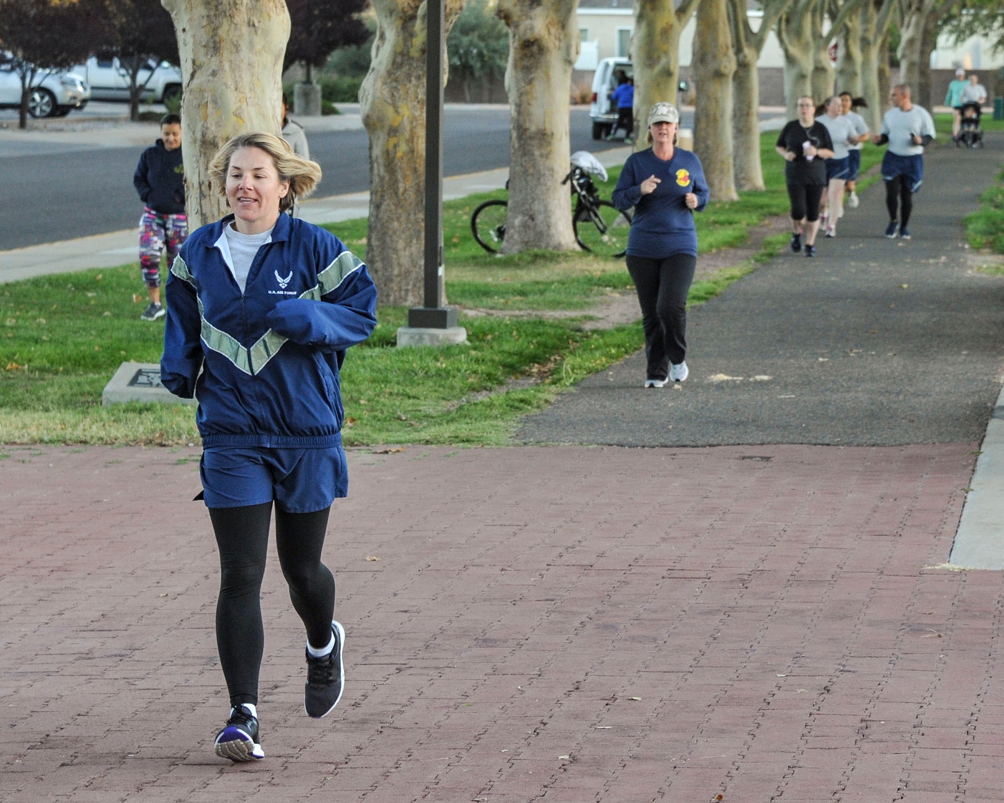 Master Sgt. Jessica De La Mora, Kirtland's Career Assistance Advisor, leads a group of runners during the "We won't back down" Suicide Prevention run/walk Sept. 28 at Hardin Field. (U.S. Air Force photo by Jim Fisher)
