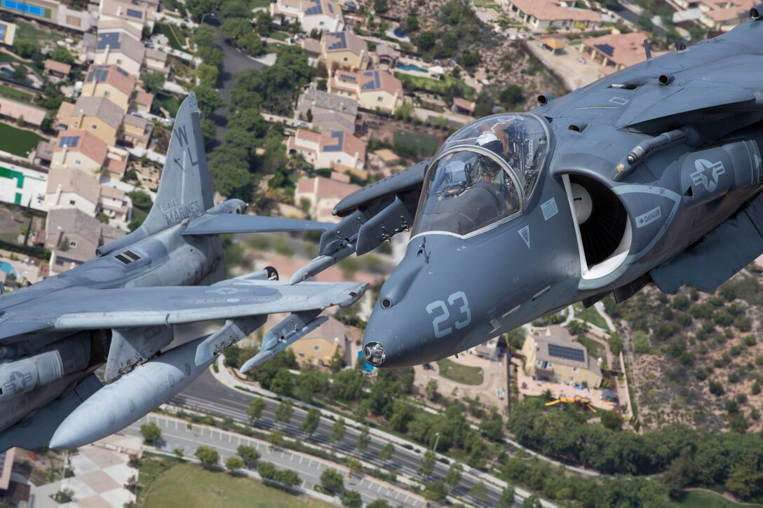 An AV-8B Harrier II flies under a C-130 during the Marine Air-Ground Task Force demonstration at the 2018 Marine Corps Air Station Miramar Air Show on MCAS Miramar, Calif., Sept. 30. This year's air show honors "100 years of women in the Marine Corps" by featuring several performances and displays that highlight the accomplishments and milestones women have made since the first female enlistee, Opha May Johnson, who joined the service in 1918. (U.S. Marine Corps photo by Lance Cpl. Maritza Vela)