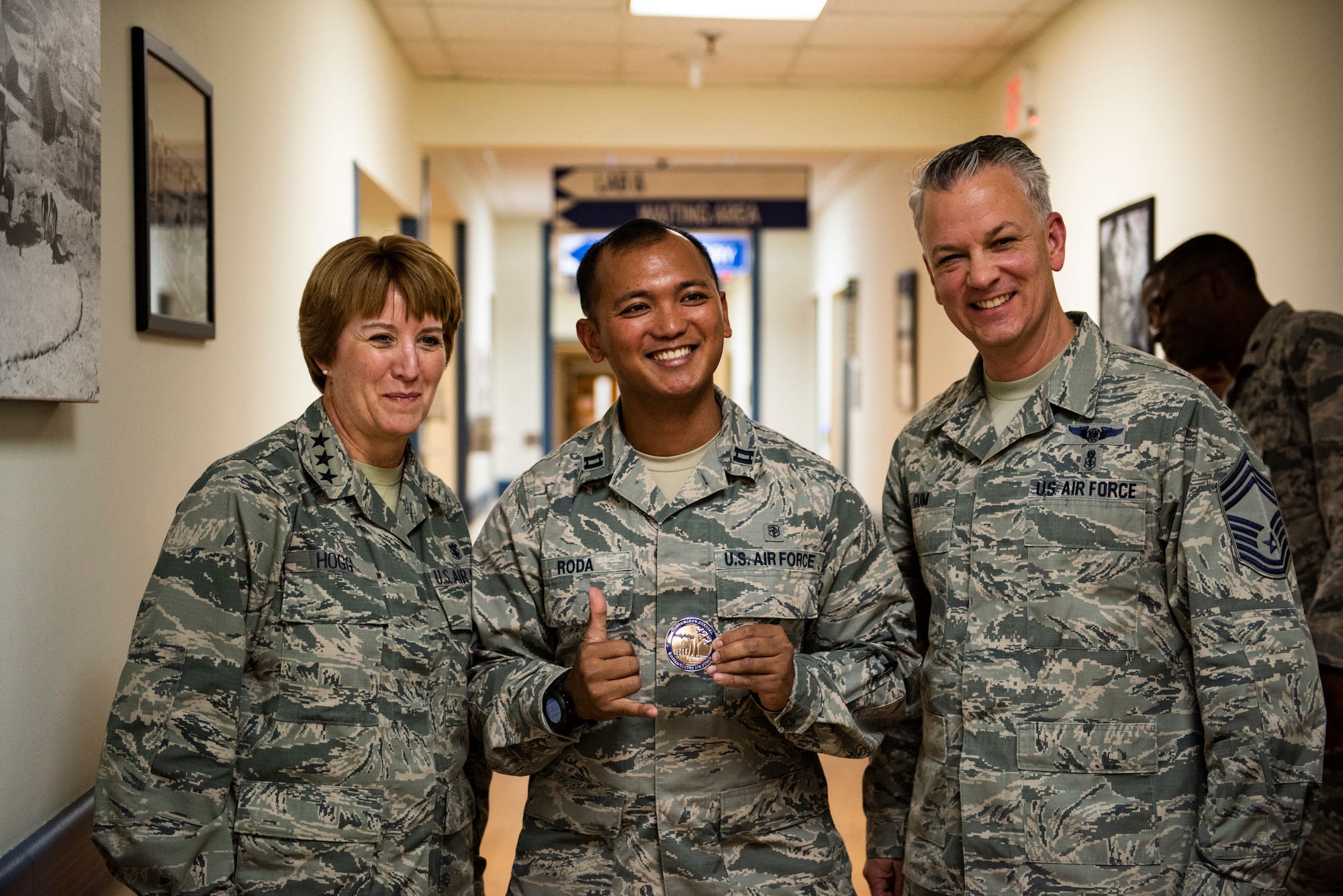 U.S. Air Force Capt. Czar Jose Roda, 8th Medical Group resource management and flight commander support staff flight commander (middle) poses for a picture with Lt. Gen. Dorothy Hogg, Air Force Surgeon General (left), and Chief MSgt. G. Steve Cum, Chief of the Medical Enlisted Force (right) at Kunsan Air Base, Republic of Korea, Sept. 25, 2018. Air Force Medical Service leadership toured the 8th MDG to assess their capabilities and talk with the Airmen that work in the clinics.