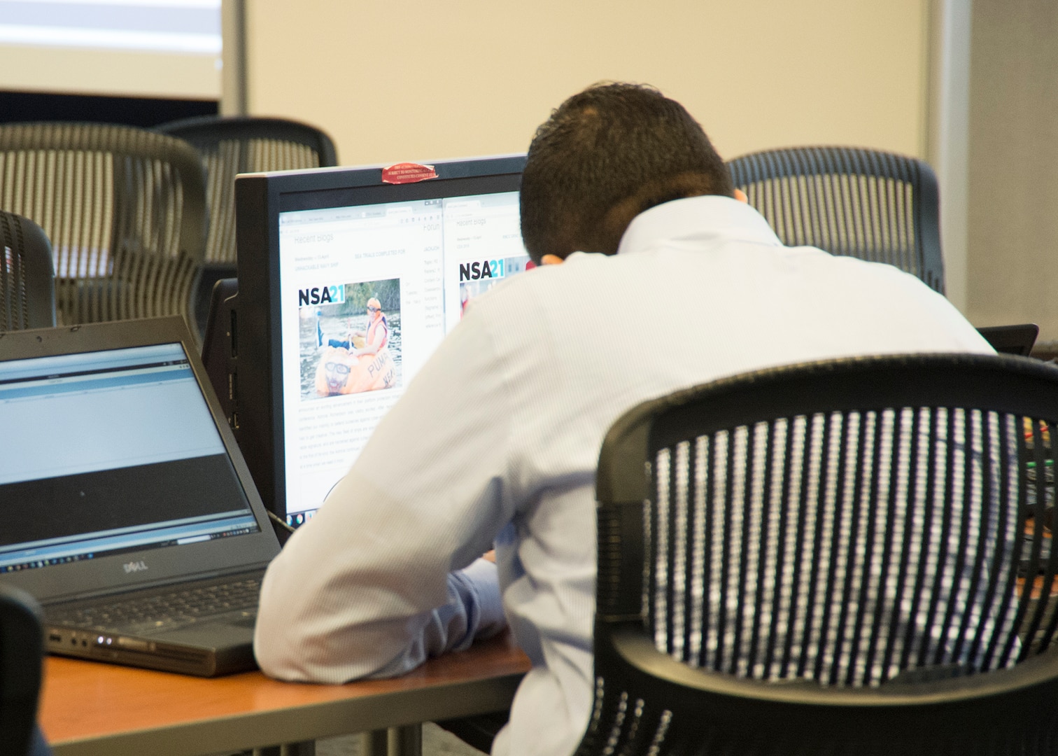 Member of the Red Cell sees the results of an attack that added the 'NSA21' logo to the participants' websites.