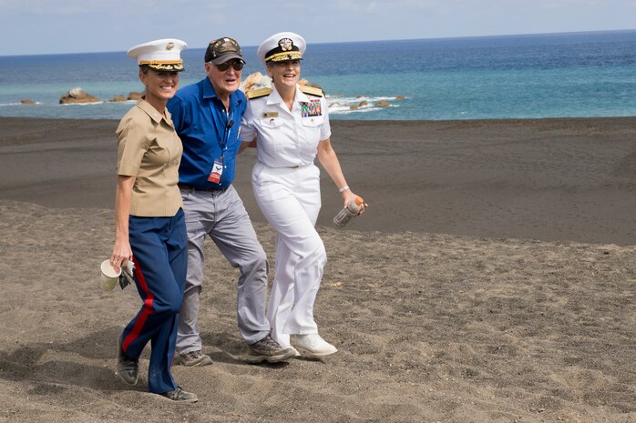 U.S. Marine Corps Col. Maura M. Hennigan, left, Ronald G. Sharfe, center, U.S. Navy veteran and U.S. Navy Rear Adm. Shoshana Chatfield, right, walk along the beaches of Iwo To, Japan March 23, 2019. The 74th Reunion of Honor ceremony remembers veterans who fought for their respective countries on Iwo To’s hallowed ground. Their sacrifice inspired peace, security and stability in the Indo-Pacific region. Hennigan, a native of Sayville, New York, is the commanding officer of Combat Logistics Regiment 3, 3rd Marine Logistics Group. Chatfield, a native of Garden Grove, California, is the commander of Joint Region Marianas. Sharfe is a native of Missoula, Montana. (U.S. Marine Corps photo by Lance Cpl. Armando Elizalde)