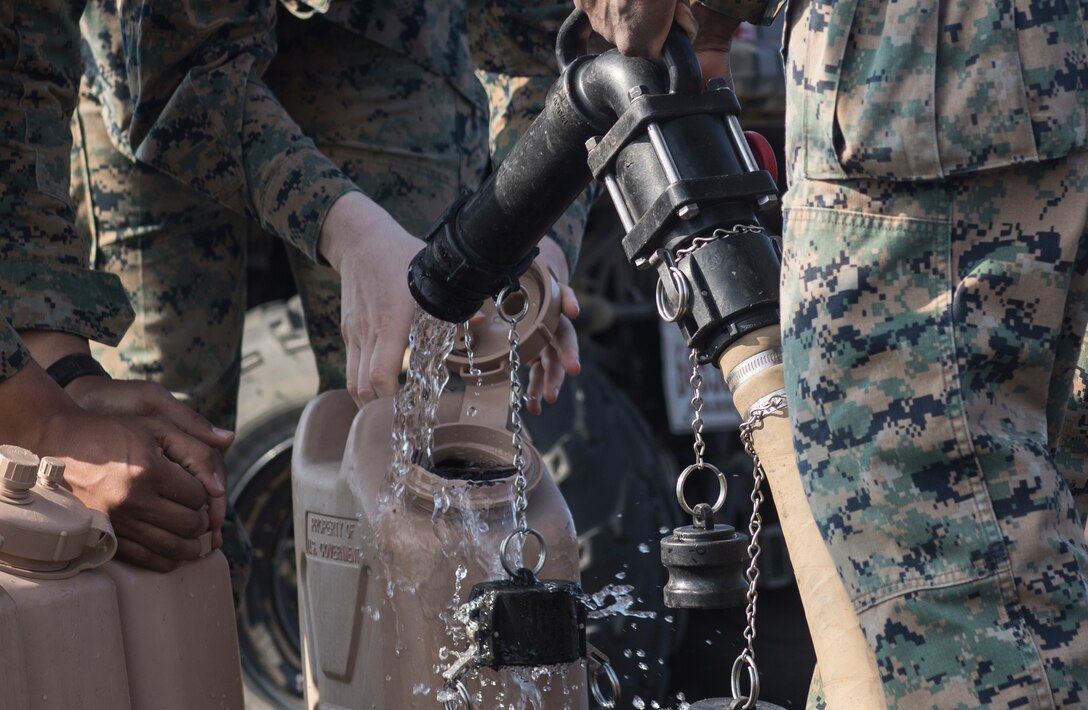 U.S. Marine Corps water support technicians with Combat Logistics Regiment 3 Support Detachment, 3rd Marine Logistics Group, fill water jugs on Iwo To, Japan March 22, 2019. The water support technicians made potable water from ocean water to be used in support of the 74th Reunion of Honor on Iwo To. More than 150 Marines and Sailors from III Marine Expeditionary Force and major subordinate commands make up the detachment tasked with all administrative and logistical support. (U.S. Marine Corps photo by Lance Cpl. Armando Elizalde)