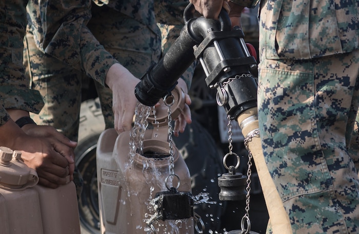 U.S. Marine Corps water support technicians with Combat Logistics Regiment 3 Support Detachment, 3rd Marine Logistics Group, fill water jugs on Iwo To, Japan March 22, 2019. The water support technicians made potable water from ocean water to be used in support of the 74th Reunion of Honor on Iwo To. More than 150 Marines and Sailors from III Marine Expeditionary Force and major subordinate commands make up the detachment tasked with all administrative and logistical support. (U.S. Marine Corps photo by Lance Cpl. Armando Elizalde)
