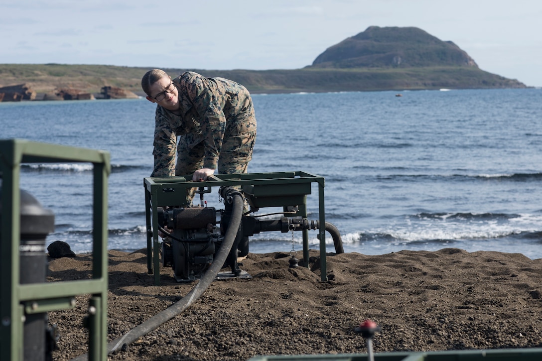 U.S. Marine Corps Lance Cpl. Danikamarie D. Lester, a water support technician with Combat Logistics Regiment 3 Support Detachment, 3rd Marine Logistics Group, turns on a suction pump on Iwo To, Japan March 22, 2019. The water support technicians made potable water from ocean water to be used in support of the 74th Reunion of Honor on Iwo To. More than 150 Marines and Sailors from III Marine Expeditionary Force and major subordinate commands make up the detachment tasked with all administrative and logistical support. Lester is a native of Deridder, Louisiana. (U.S. Marine Corps photo by Lance Cpl. Armando Elizalde)