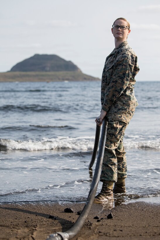 U.S. Marine Corps Lance Cpl. Danikamarie D. Lester, a water support technician with Combat Logistics Regiment 3 Support Detachment, 3rd Marine Logistics Group, adjusts a suction hose on Iwo To, Japan March 22, 2019. The water support technicians made potable water from ocean water to be used in support of the 74th Reunion of Honor on Iwo To. More than 150 Marines and Sailors from III Marine Expeditionary Force and major subordinate commands make up the detachment tasked with all administrative and logistical support. Lester is a native of Deridder, Louisiana. (U.S. Marine Corps photo by Lance Cpl. Armando Elizalde)