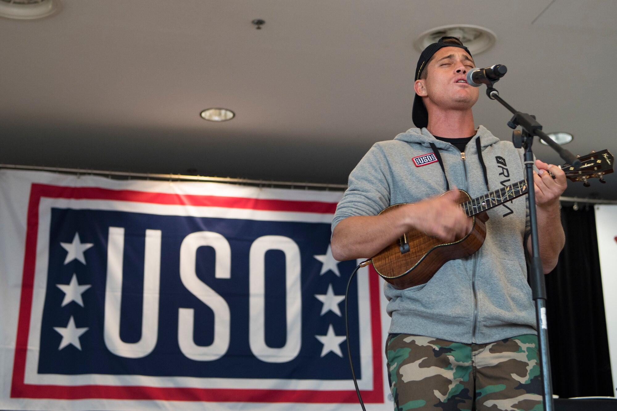 Rothman plays his ukulele and sings a song native to his state of Hawaii as part of a USO Spring Visit on Ramstein Air Base, Germany, March 30, 2019.