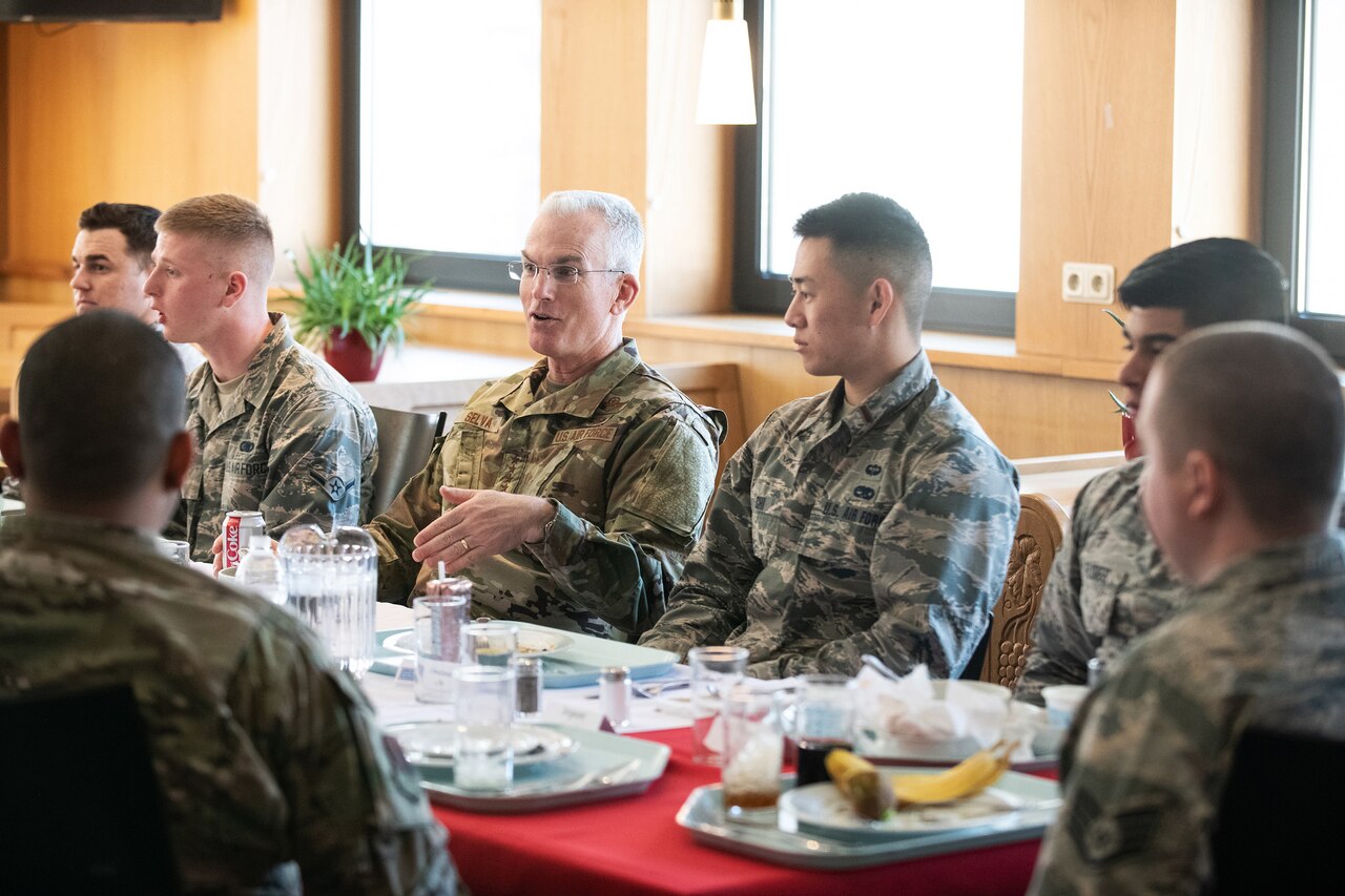 Air Force Gen. Paul J. Selva sits at a table for lunch with troops.
