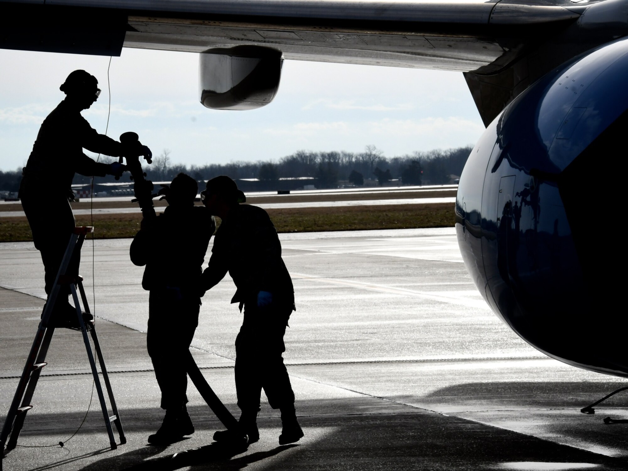 Fuel technicians get ready to add jet petroleum into a waiting C-40C aircraft on March 14, 2019 at Scott Air Force Base, Illinois as they prep it for another flight.  The 932nd Airlift Wing's Maintenance Group (MXG), is responsible for leading people who are always training and equipping to inspect, maintain and repair Air Force Reserve Command C-40C planes at Scott Air Force Base. The 932nd MXG's management of resources improves the wing's professionalism and enables the 932nd Operations Group's C-40C pilots to fly distinguished visitor (DV) airlift around the world, anywhere they are needed by the nation's leaders. The Illinois unit, which is part of 22nd Air Force, under Air Force Reserve Command, flies four of the C-40C planes worldwide. (U.S. Air Force photo by Lt. Col. Stan Paregien)