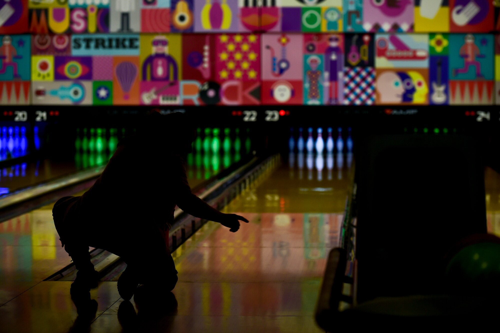 A Team Ramstein spouse teaches her daughter how to bowl during the Deployed Family Dinner at the Vogelweh Bowling Alley on Vogelweh Military Complex, Germany, March 28, 2019. The 86th Force Support Squadron Airman and Family Readiness Center hosted a free night of bowling and dinner for the families of deployed Team Ramstein members. (U.S. Air Force photo by Staff Sgt. Jonathan Bass)