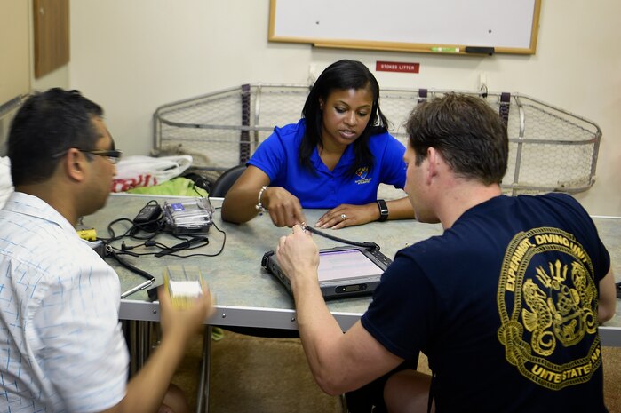 Lakeisha Williams, scientist/principal investigator, Naval Information Warfare Center (NIWC) Atlantic, explains how to use the Office of Naval Research TechSolutions-sponsored Scuba Binary Dive Application to a Navy diver during a demonstration and evaluation underway period off the coast of Panama City, Fla.