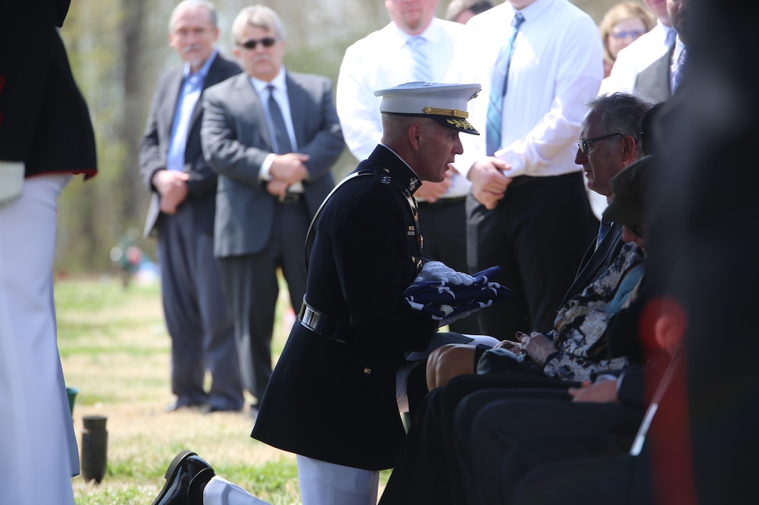 Lieutenant Gen. Mark A. Brilakis, commanding general, U.S. Marine Corps Forces Command, consoles a family member during a full honors funeral for retired Marine Lt. Col. Howard V. Lee, Medal of Honor recipient, at Colonial Grove Memorial Park, Virginia Beach, Virginia, March 30, 2019. Lee received the Medal of Honor for his actions during the Vietnam War in August 1966. While on an operation deep in enemy territory, Lee’s platoon was attacked and surrounded by a large Vietnamese force. Realizing his unit suffered numerous casualties and fully aware the platoon remained under heavy attack, Lee took seven men and proceeded by helicopter to provide reinforcements. After fearlessly moving from position to position and encouraging his men to keep fighting, he was wounded by fragments from an enemy grenade in several areas of his body, including his eye. Despite his wounds, Lee continued optimistically throughout the night to direct a valiant defense, coordinate supporting fires, and apprise higher headquarters of the plight of the platoon. Lee retired at the rank in 1975, after 20 years of service. Lee passed away March 23, 2019; he was 85.