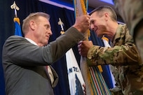 U.S. Acting Secretary of Defense Patrick M. Shanahan passes the colors to the incoming commander of U.S. Special Operations Command, Army Gen. Richard D. Clarke, during the change of command ceremony, Tampa, Florida, March 29, 2019.