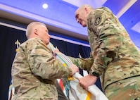 Senior Enlisted Advisor to U.S. Special Operations Command Army Sgt. Maj. Patrick L. McCauley passes the colors to the outgoing commander, Army Gen. Raymond A. Thomas, during the change of command ceremony, Tampa, Florida, March 29, 2019.
