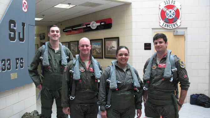 Airmen from the 26th Operational Weather Squadron (OWS) pose for a photo with pilots from the 333rd Fighter Squadron at Seymour Johnson Air Force Base, North Carolina, Feb. 21, 2019. The 26th OWS Airmen were given a familiarization flight aboard two F-15E Strike Eagle aircraft to see firsthand how their weather products affect the fighters’ mission. (Courtesy photo)