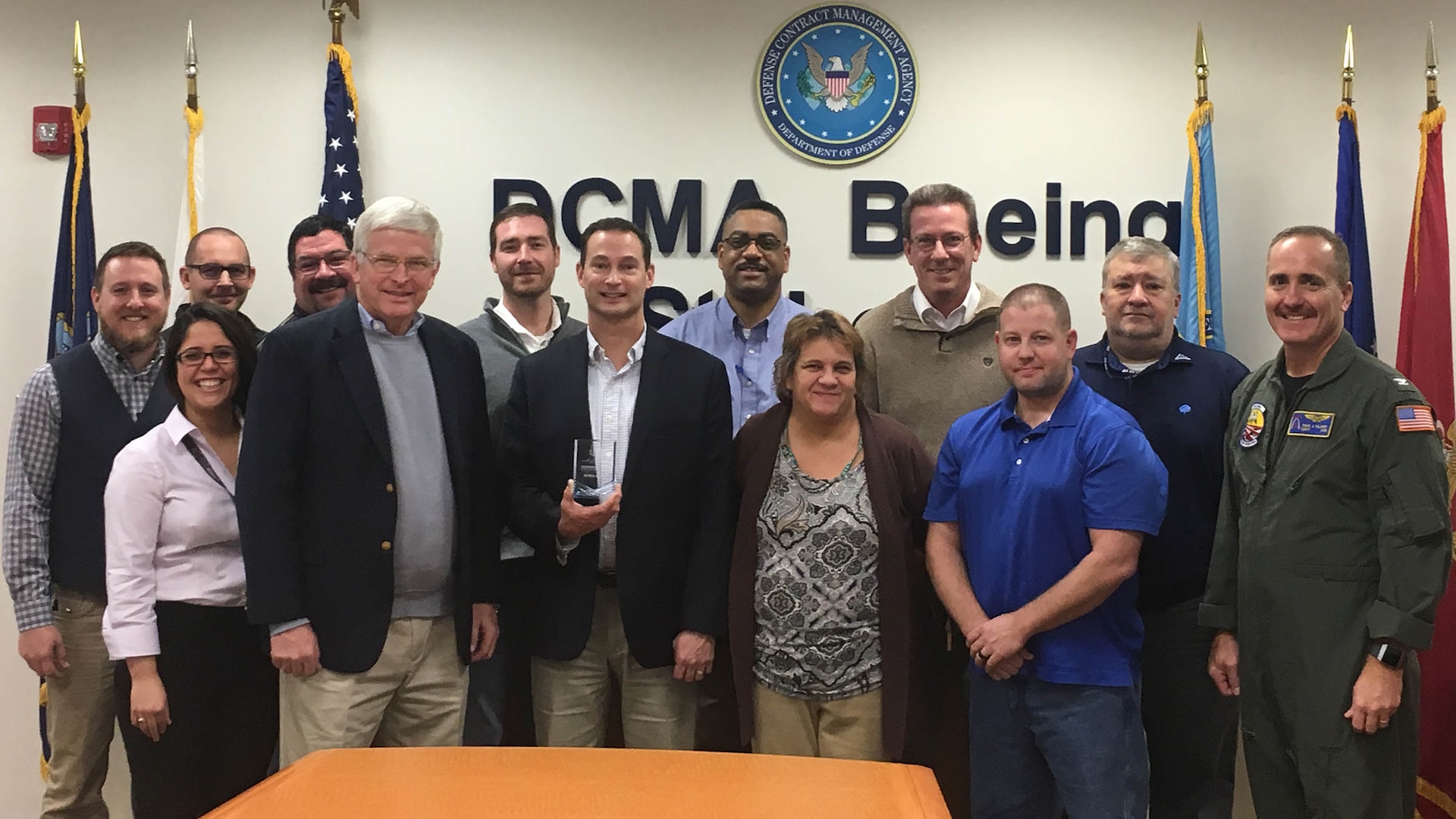 A group of DCMA team members stand together after receiving award.