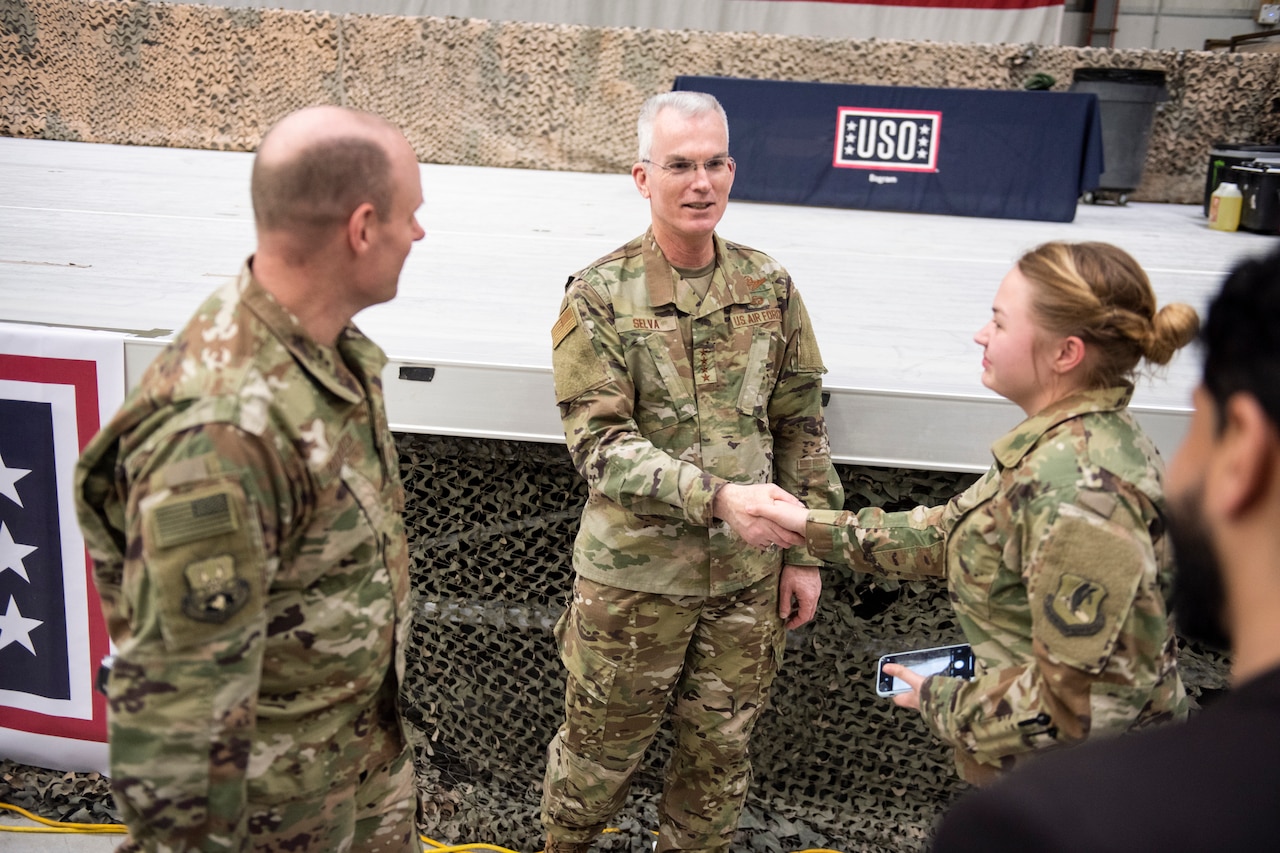 Air Force Gen. Paul J. Selva, vice chairman of the Joint Chiefs of Staff, shakes hands with a woman while a man stands next to them.