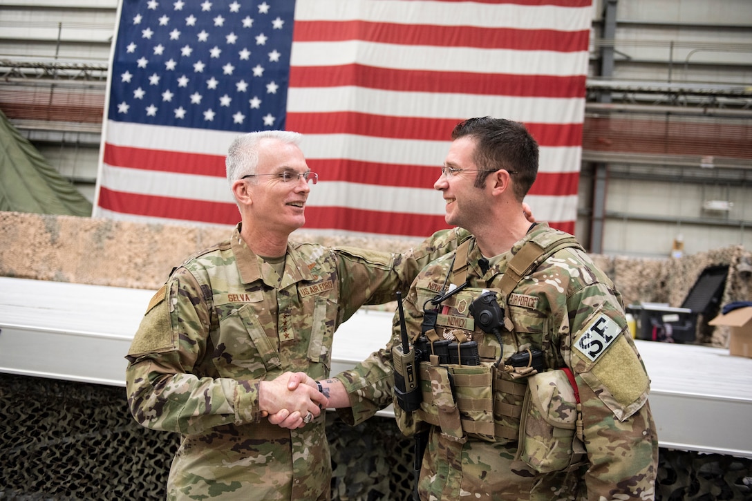 Air Force Gen. Paul J. Selva, vice chairman of the Joint Chiefs of Staff, shakes hands with an airman.