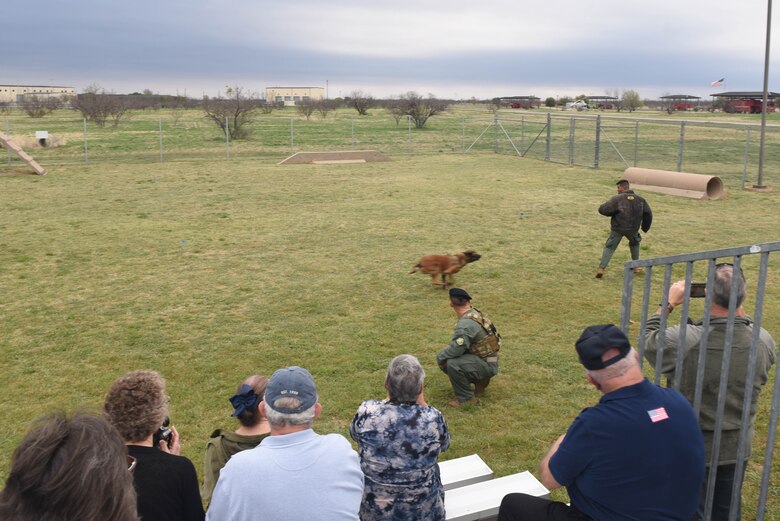 U.S. Air Force 17th Security Forces military working dogs put on demonstrations for guests of the Fritz Military Working Dog Kennel unveiling on Goodfellow Air Force Base, Texas, March 29, 2019. During the demonstration, guests saw the dogs run an obstacle course and witnessed how they assist their handlers with vehicle stops and on foot. (U.S. photo by Airman 1st Class Zachary Chapman/Released)