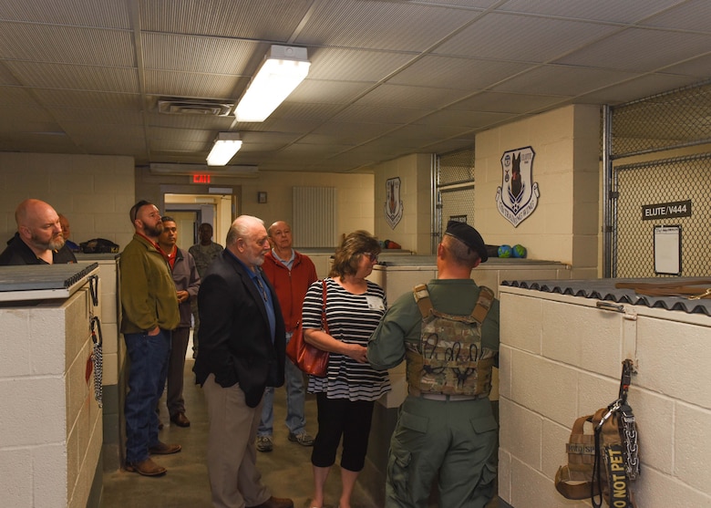 U.S. Air Force Staff Sgt. Dakoda Riddle, 17th Security Forces military working dog trainer, guides guests through the newly renamed Fritz MWD Kennel on Goodfellow Air Force Base, Texas, March 29, 2019. The unveiling began with a ceremony, followed by a tour and demonstration put on by the dog handlers, lastly there was a display arranged in memory of Sgt. Gerald Fritz. (U.S. photo by Airman 1st Class Zachary Chapman/Released)