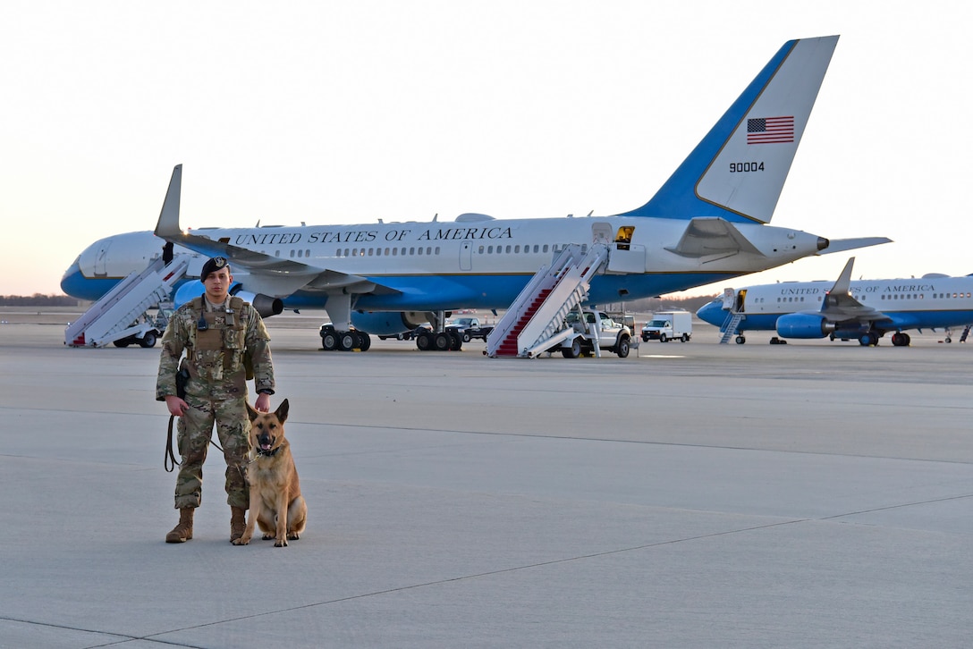 Senior Airman Nathan White, 11th Security Support Squadron military working dog handler, and his dog, Toro, pose for a photo on Joint Base Andrews Md., March 28, 2019. The two have worked together for ten months to patrol the base and sweep areas for potential threats to JBA. (U.S. Air Force photo by Airman 1st Class Noah Sudolcan)