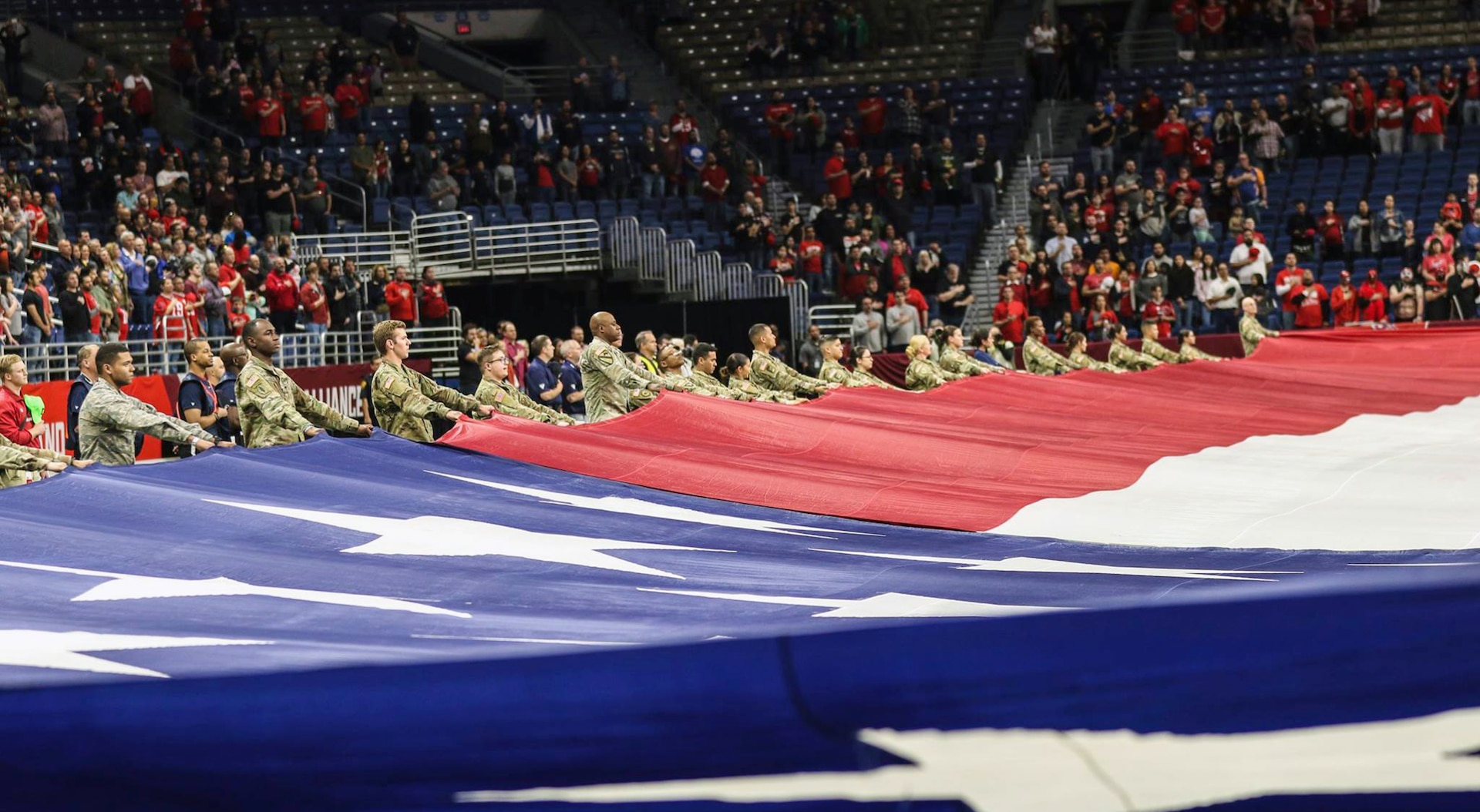 To honor military members past and present, service members from across Joint Base San Antonio, as well as ROTC cadets from the University of Texas at San Antonio, presented the American flag during the National Anthem at the San Antonio Commanders football game at the Alamodome in downtown San Antonio March 31. More than 100 Service members and cadets participated in the flag-holding ceremony to open Sunday's game.