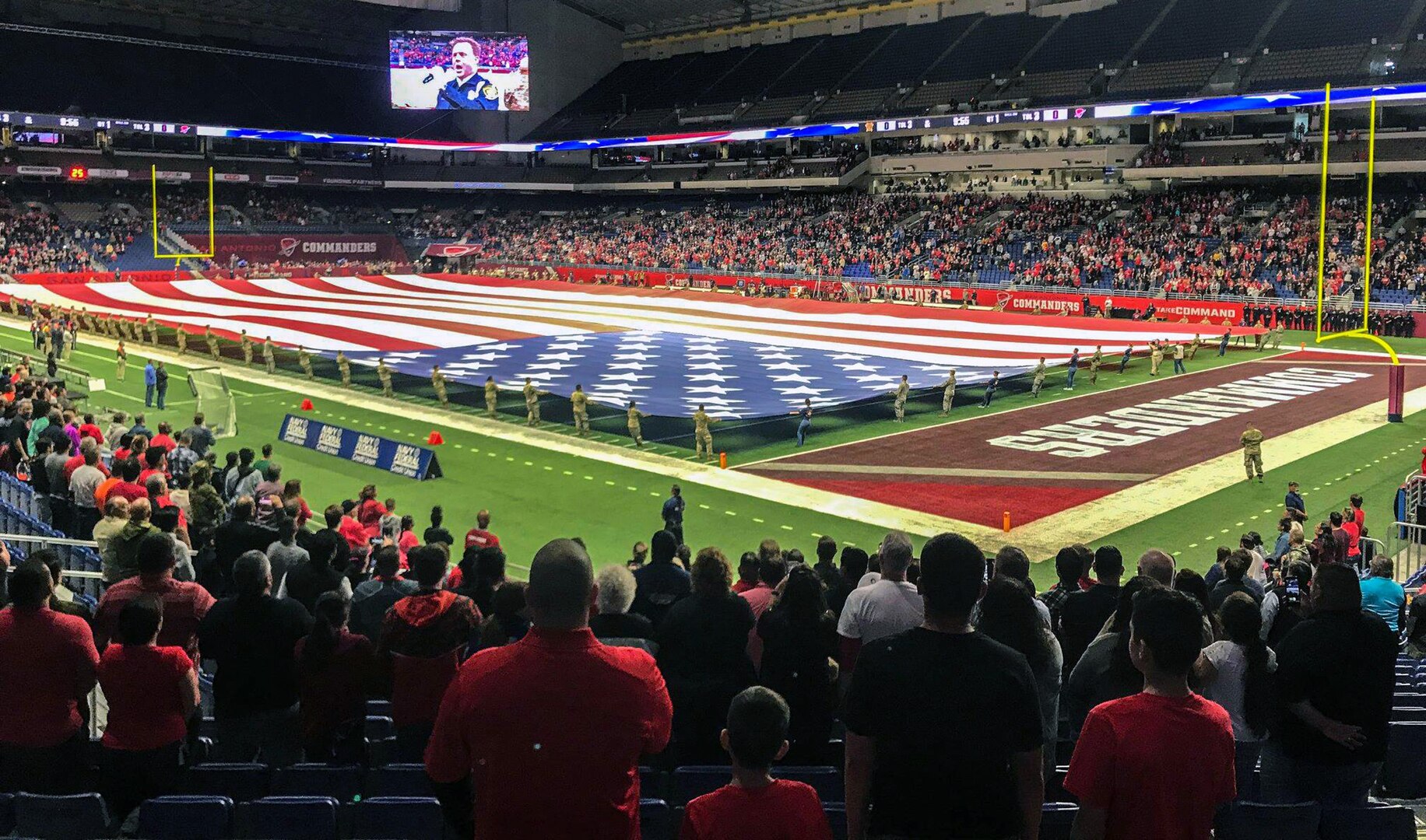 To honor military members past and present, service members from across Joint Base San Antonio, as well as ROTC cadets from the University of Texas at San Antonio, presented the American flag during the National Anthem at the San Antonio Commanders football game at the Alamodome in downtown San Antonio March 31. More than 100 Service members and cadets participated in the flag-holding ceremony to open Sunday's game.