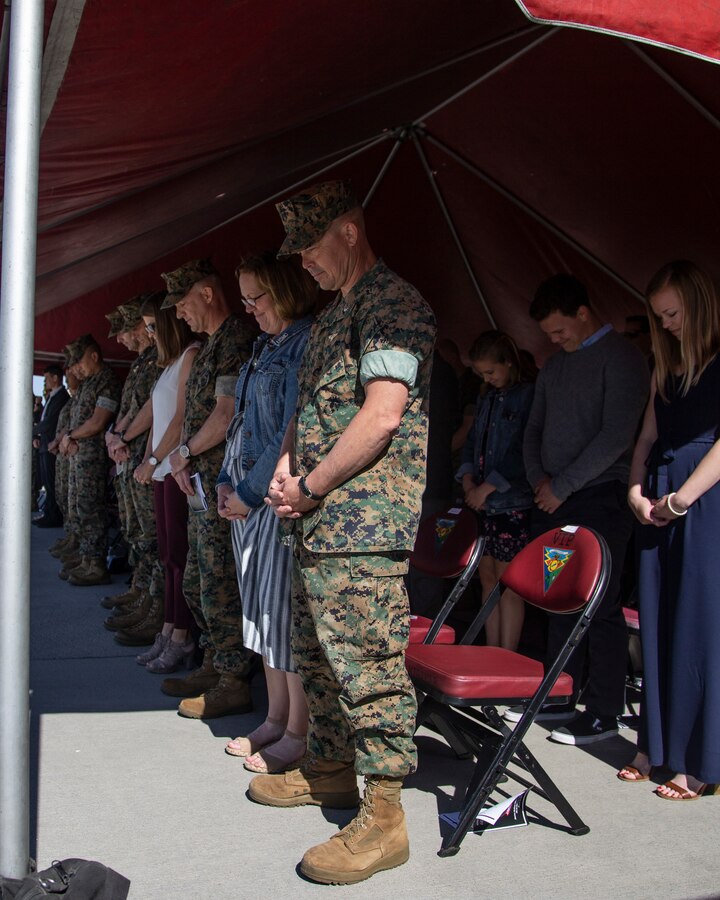 Marine Lt. Col. Charles E. Bodwell, center, outgoing commanding officer of Marine Medium Tiltrotor Squadron 166, Marine Aircraft Group 16, 3rd Marine Aircraft Wing and guest bow during the invocation prior to the change of command ceremony at Marine Corps Air Station Miramar, Calif., March 28, 2019. The passing of the colors from Bodwell to Lt. Col. James C. Ford III signifies the transfer of responsibility, authority and accountability from the outgoing commanding officer to the incoming commanding officer. (U.S. Marine Corps photo by Cpl. Samuel Ruiz)