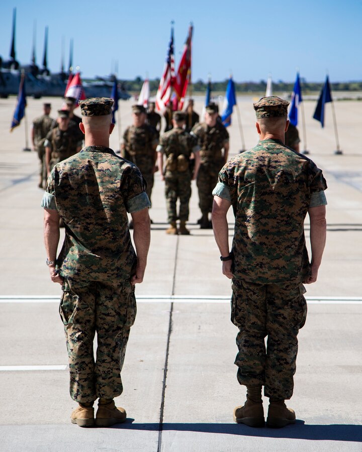 Lt. Col Charles E. Bodwell, right, Marine Medium Tiltrotor Squadron (VMM) 166, Marine Aircraft Group (MAG) 16, 3rd Marine Aircraft Wing (MAW) and Lt. Col. James C. Ford III, commanding officer of VMM-166, MAG-16, 3rd MAW, stand at attention awaiting the passing of the colors during a change of command ceremony at Marine Corps Air Station Miramar, Calif., March 28, 2019. The passing of the colors from Bodwell to Ford signifies the transfer of responsibility, authority and accountability from the outgoing commanding officer to the incoming commanding officer. (U.S. Marine Corps photo by Cpl. Samuel Ruiz)