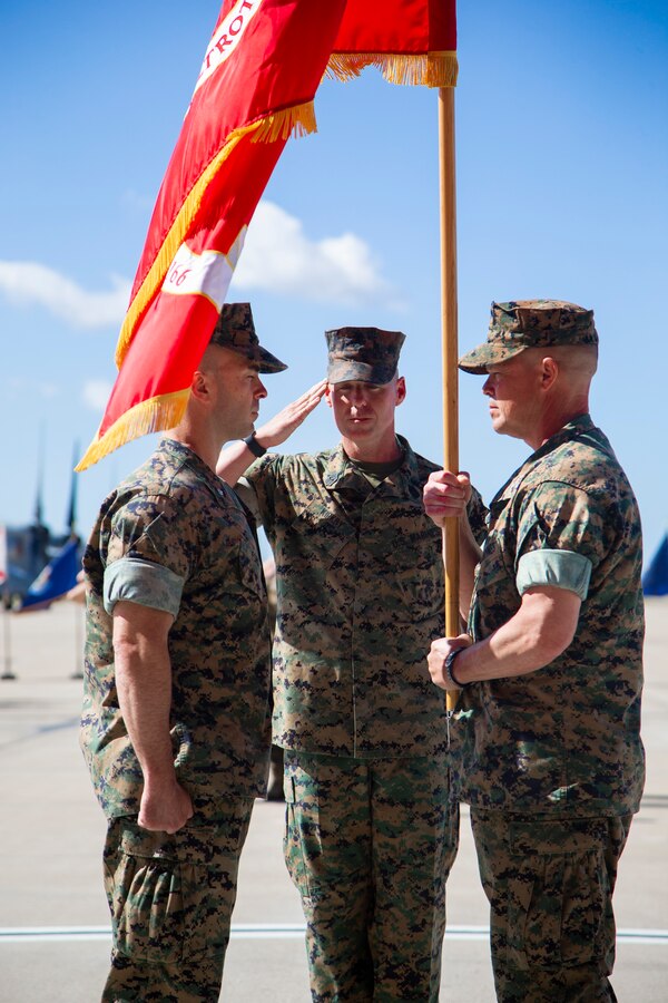 Marine Sgt. Maj. Garett G. Kirkby, sergeant major of Marine Medium Tiltrotor Squadron (VMM) 166, Marine Aircraft Group (MAG) 16, 3rd Marine Aircraft Wing (MAW), salutes the passing of the colors from Lt. Col Charles E. Bodwell, VMM-166, MAG-16, 3rd MAW to Lt. Col. James C. Ford III, commanding officer of VMM-166, MAG-16, 3rd MAW, during a change of command ceremony at Marine Corps Air Station Miramar, Calif., March 28, 2019. The passing of the colors from Bodwell to Ford signifies the transfer of responsibility, authority and accountability from the outgoing commanding officer to the incoming commanding officer. (U.S. Marine Corps photo by Cpl. Samuel Ruiz)