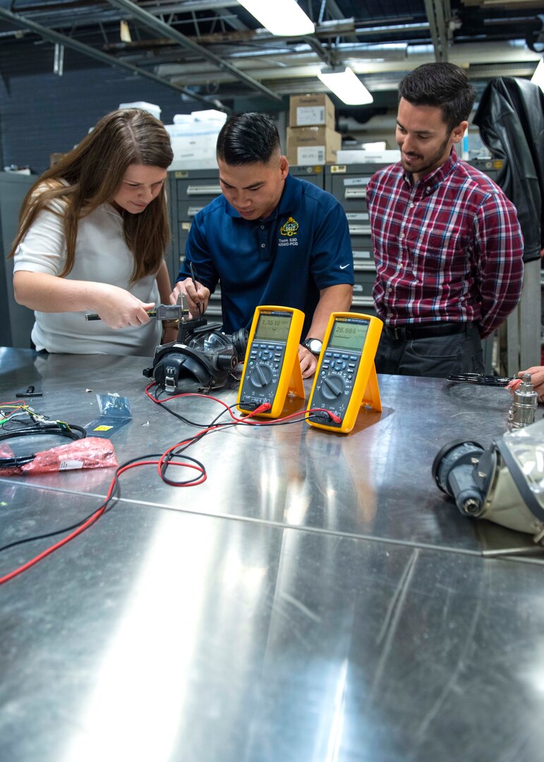PANAMA CITY, Florida - The LED Air Warning System team from Naval Surface Warfare Center Panama City Division, in collaboration with local academia and an industry partner, has been selected by the Federal Laboratory Consortium to receive one of its highest honors – a 2019 Excellence in Technology Transfer Award.Pictured from left to right: Allie Williams, Tien Le, and Hayden DeForge. U.S. Navy photo by Eddie Green