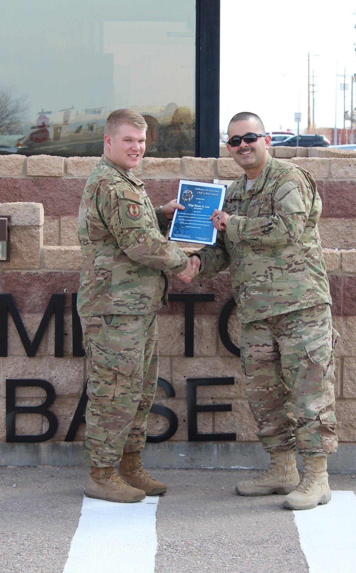 (From right to left) Chief Master Sgt. Manuel Silva, 635th Materiel Maintenance Support Squadron superintendent, presents the Chief’s Choice Award to Staff Sgt. Brian Lee, 635th MMSS noncommissioned officer in charge of service support, March 27, 2019, on Holloman Air Force Base, N.M. Holloman’s Chiefs Group has a monthly recognition program titled Chief’s Choice Award. Every month a chief has the honor of choosing a deserving Airman for an outstanding act or for continuous outstanding performance. (Courtesy photo)