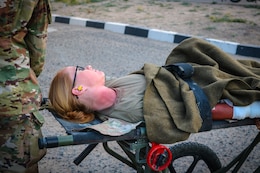 A mock casualty lies on stretcher during the Golden Trident mass casualty training exercise at Camp Arifjan, Kuwait, March 21, 2019.