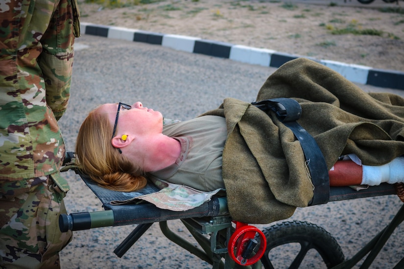 A mock casualty lies on stretcher during the Golden Trident mass casualty training exercise at Camp Arifjan, Kuwait, March 21, 2019.