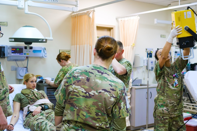 U.S. Army Soldiers assigned to the 452d Combat Support Hospital provide medical care during the Golden Trident mass casualty training exercise at Camp Arifjan, Kuwait, March 21, 2019.