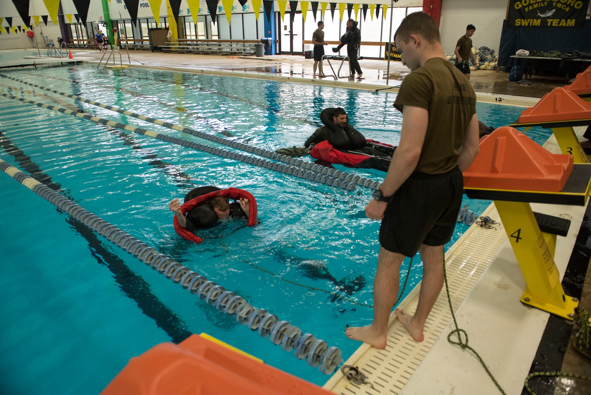 Airman 1st Class Zachary Perdue, 4th Component Maintenance Squadron egress apprentice, watches as an aircrew member gets into a rescue device during water survival training, March 26, 2019, at the Goldsboro YMCA, North Carolina. Perdue, a survival, evasion, resistance and escape augmentee, and all other SERE augmentees at Seymour Johnson Air Force Base, NC, must complete the same training that they are helping with in order to better provide realistic training. (U.S. Air Force photo by Senior Airman Kenneth Boyton)